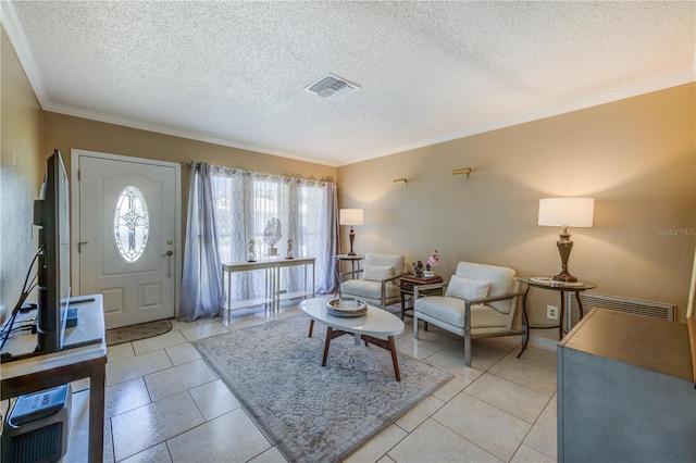 living room featuring light tile patterned floors, a textured ceiling, and ornamental molding