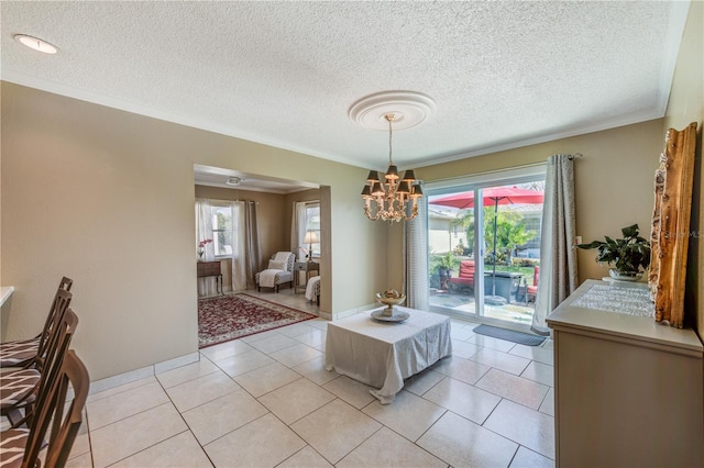 tiled dining room featuring crown molding, a textured ceiling, and a notable chandelier