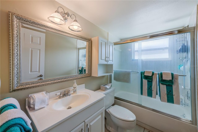 full bathroom with toilet, combined bath / shower with glass door, vanity, and tile patterned floors