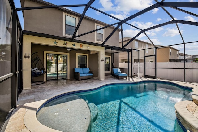 view of swimming pool featuring a patio, an outdoor living space, and a lanai