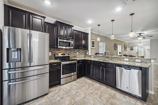 kitchen with hanging light fixtures, stainless steel appliances, kitchen peninsula, ornamental molding, and sink