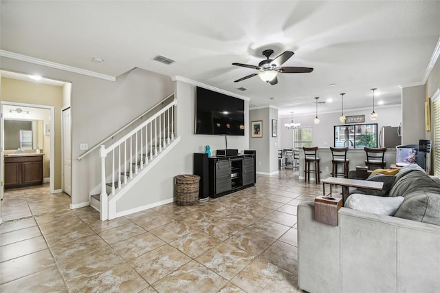 living room with ornamental molding and ceiling fan with notable chandelier