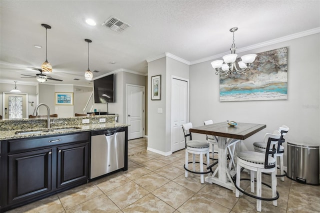 kitchen with ornamental molding, sink, stainless steel dishwasher, ceiling fan with notable chandelier, and stone counters