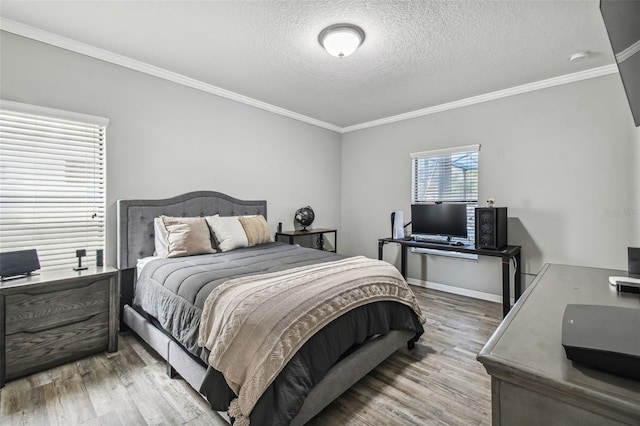 bedroom featuring crown molding, a textured ceiling, and light hardwood / wood-style flooring