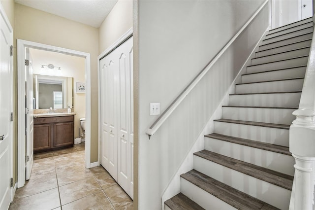 staircase with tile patterned flooring