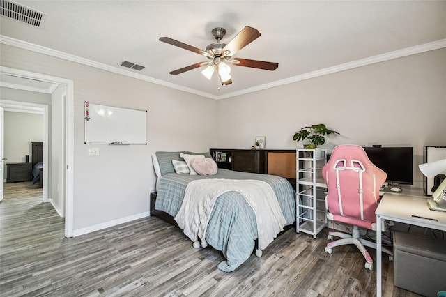 bedroom with ornamental molding, wood-type flooring, and ceiling fan