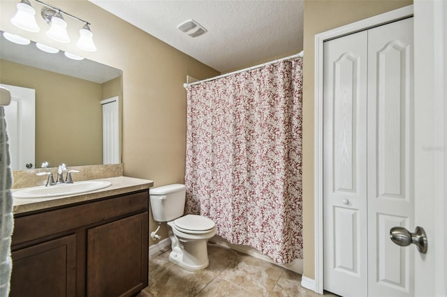 bathroom featuring a textured ceiling, toilet, vanity, a shower with curtain, and tile patterned flooring