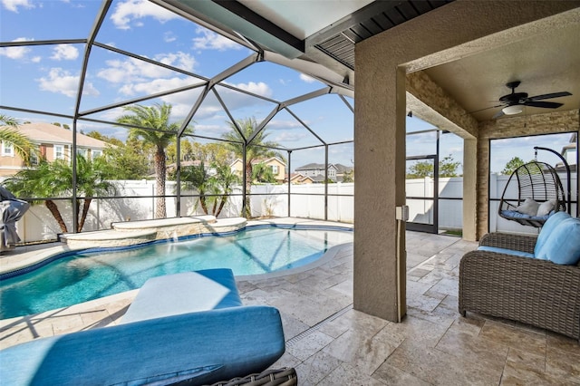 view of pool featuring a patio, pool water feature, a lanai, and ceiling fan