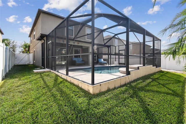 back of house with a patio area, glass enclosure, a fenced in pool, and a lawn