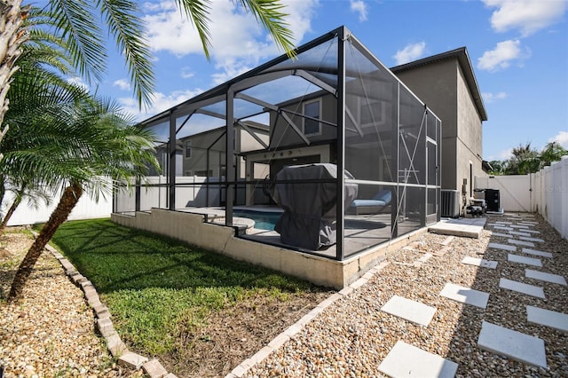 view of side of home with a yard, central AC unit, a lanai, a patio area, and a fenced in pool