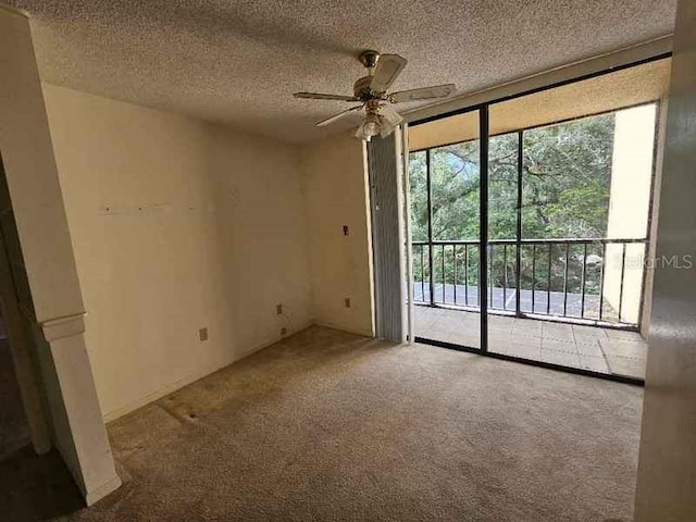 unfurnished room featuring a textured ceiling, carpet, and ceiling fan