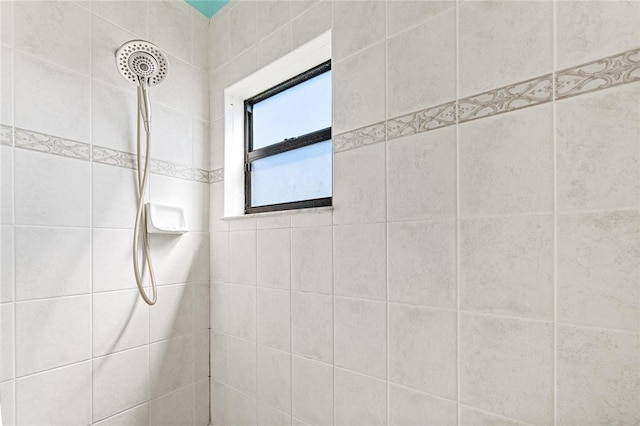 bathroom with tiled shower