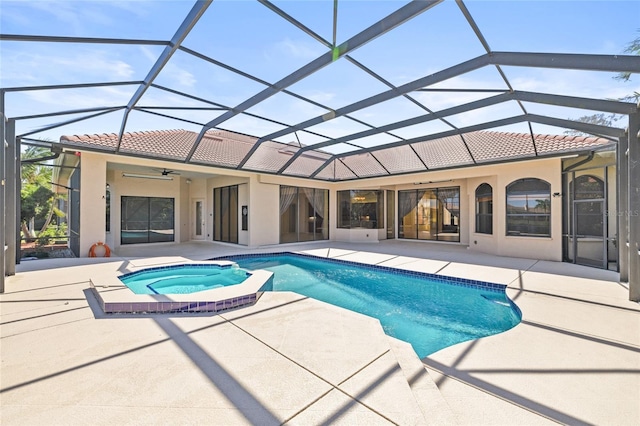 view of pool with a lanai, a patio area, ceiling fan, and an in ground hot tub