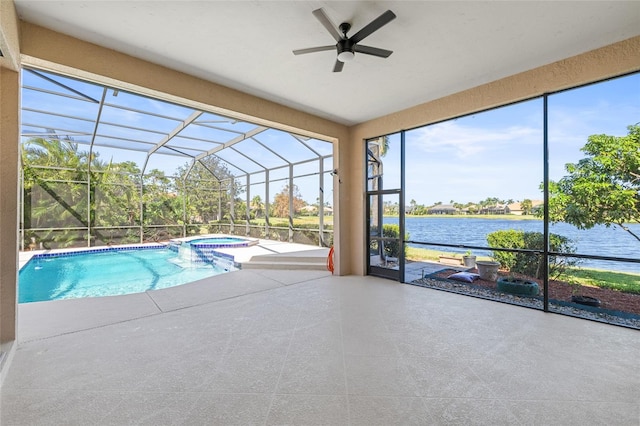 view of swimming pool with glass enclosure, a water view, ceiling fan, an in ground hot tub, and a patio area