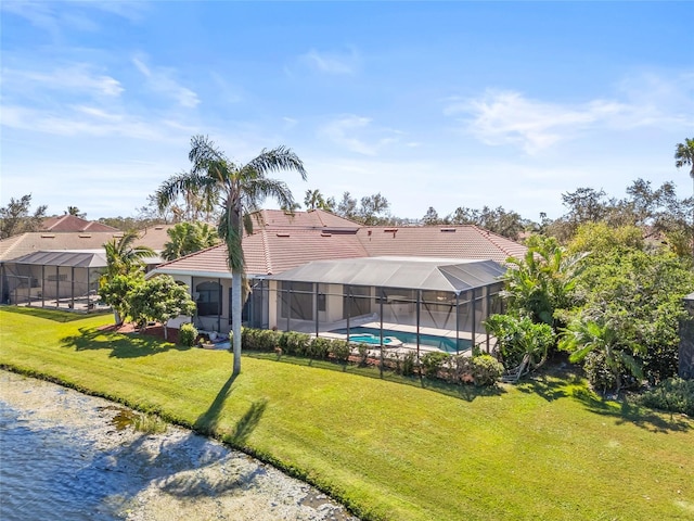 back of house featuring a yard, a lanai, and a fenced in pool