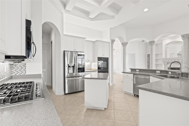 kitchen featuring a center island, stainless steel appliances, white cabinetry, and sink