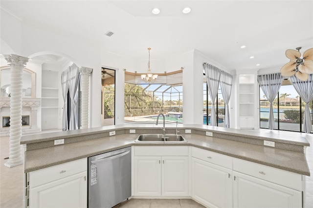 kitchen with white cabinets, stainless steel dishwasher, a wealth of natural light, and sink