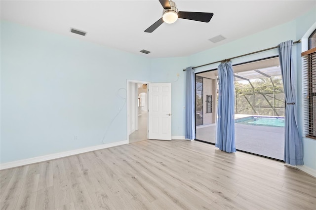 empty room with ceiling fan and light hardwood / wood-style flooring