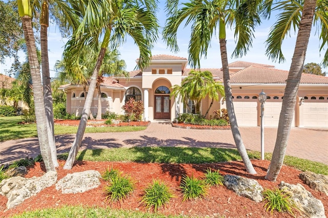 mediterranean / spanish-style home with a garage