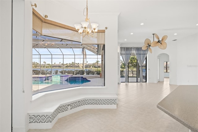 interior space with a chandelier, plenty of natural light, and ornamental molding