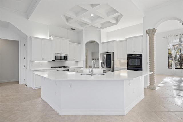 kitchen with sink, white cabinets, a high ceiling, a large island with sink, and stainless steel appliances