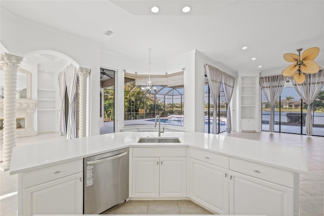 kitchen with sink, dishwasher, ceiling fan, white cabinets, and built in shelves