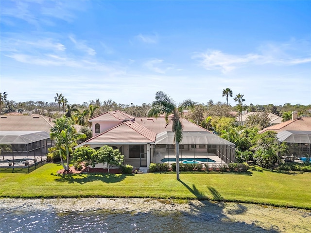 rear view of property with a water view, glass enclosure, and a lawn