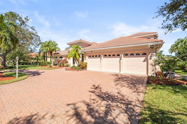 mediterranean / spanish-style home with a garage