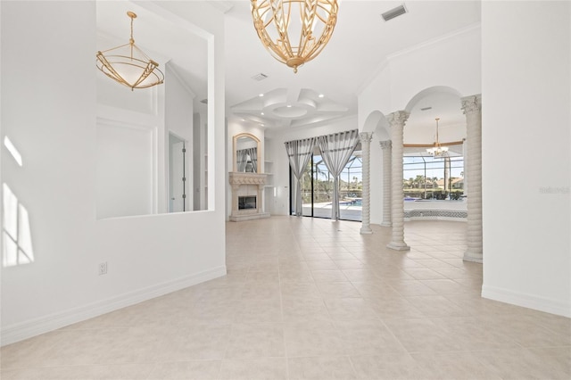 unfurnished living room with a notable chandelier, light tile patterned floors, ornamental molding, and decorative columns