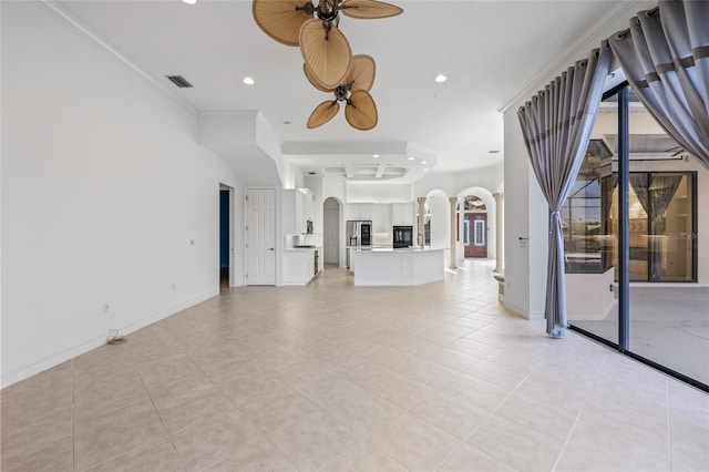 unfurnished living room featuring ornamental molding, ceiling fan, and light tile patterned flooring