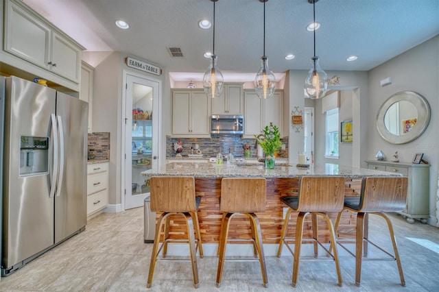 2001 Palm Key Ave, Oldsmar, FL 34677 - kitchen with visible vents, backsplash, a healthy amount of sunlight, and stainless steel appliances