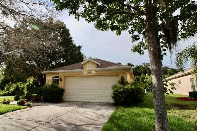 view of front of house with a front yard and a garage