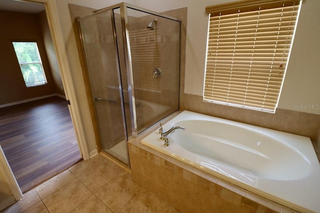 bathroom featuring separate shower and tub and hardwood / wood-style floors