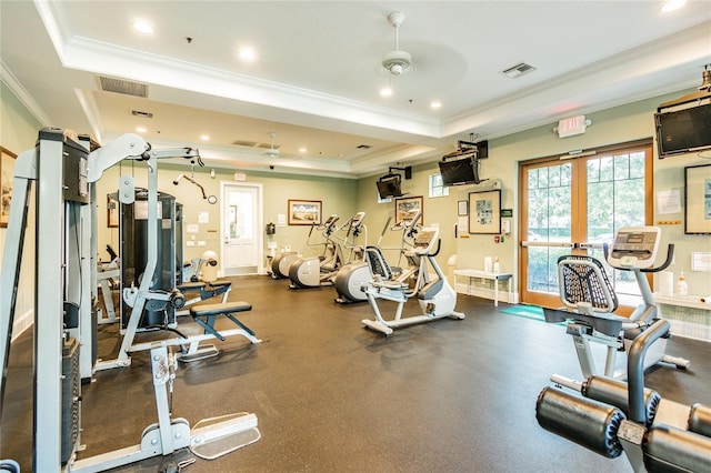 exercise room with crown molding, ceiling fan, and a raised ceiling