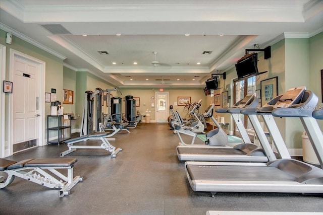 workout area featuring crown molding and a raised ceiling