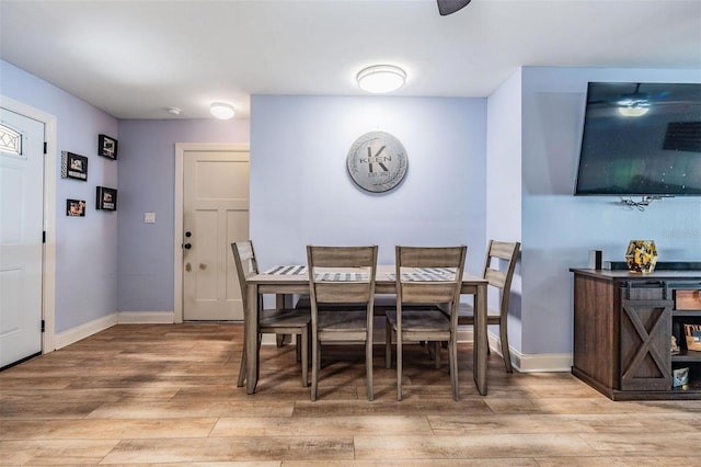 dining space with light wood-type flooring