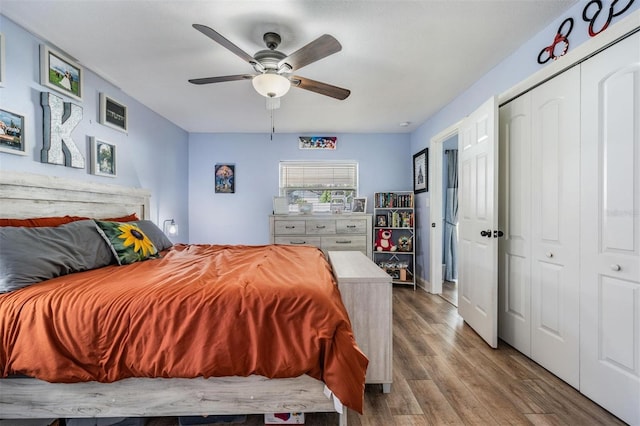 bedroom with hardwood / wood-style floors, a closet, and ceiling fan