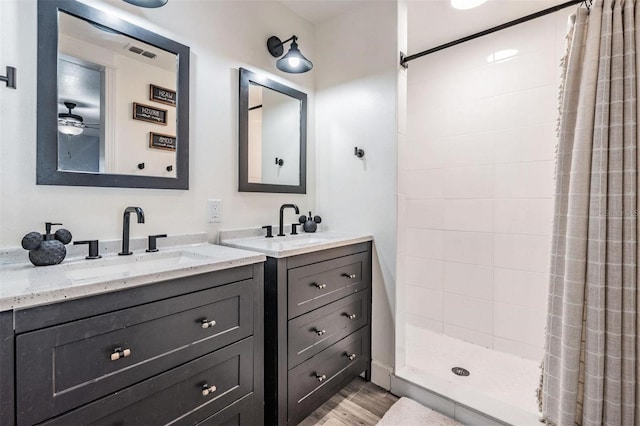 bathroom featuring vanity, a shower with shower curtain, and hardwood / wood-style floors