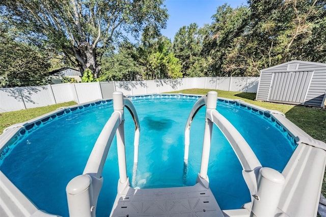 view of pool with a storage unit and a lawn