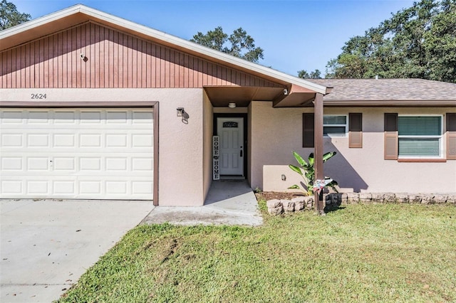 view of front of property with a front yard and a garage