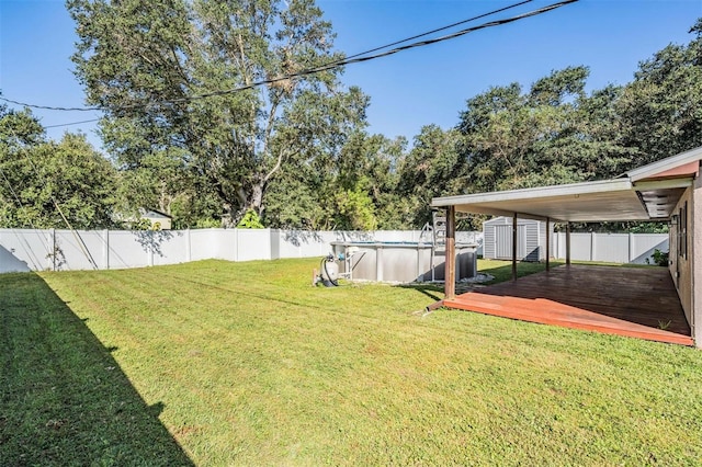 view of yard featuring a shed and a pool side deck