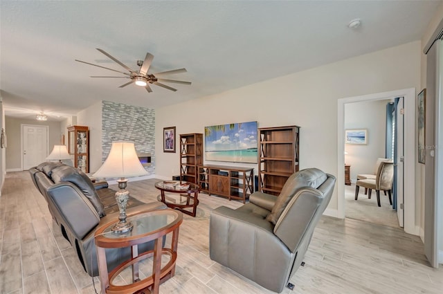 living room featuring ceiling fan and light hardwood / wood-style floors