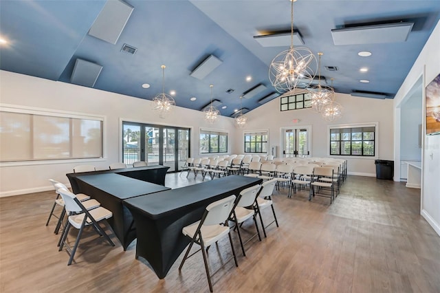 playroom with hardwood / wood-style flooring, lofted ceiling, and a chandelier