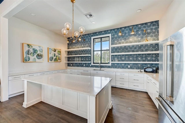 kitchen featuring high quality fridge, white cabinets, a center island, sink, and dark hardwood / wood-style floors