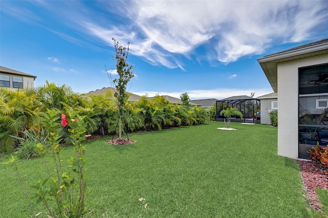 view of yard featuring glass enclosure