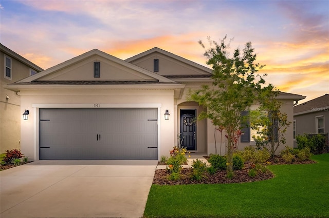 view of front of house featuring a garage and a yard