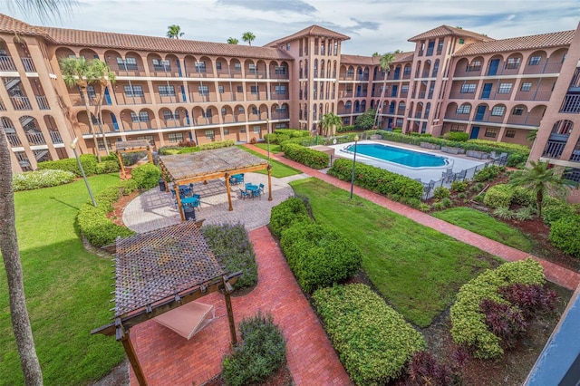 view of pool with a patio area and a yard