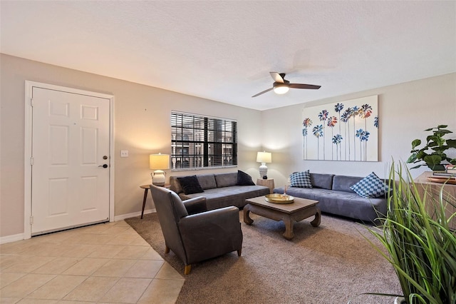 tiled living room with a textured ceiling and ceiling fan