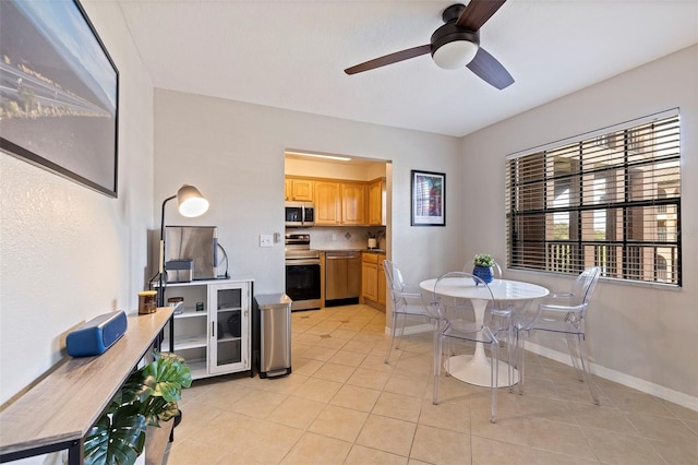 tiled dining room featuring ceiling fan