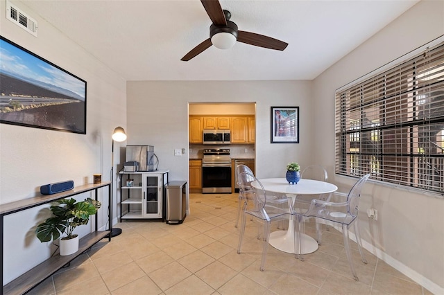 tiled dining room with ceiling fan